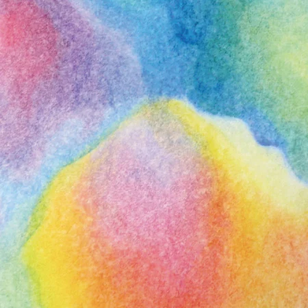 A close up detail of a mandala painting with oil colours displaying harmonious layers of rainbow colours overlapping and interacting